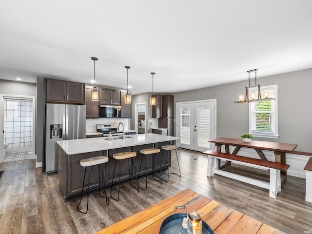 541 S Kelsey Ave, Evansville, IN 47714 - kitchen with appliances with stainless steel finishes, a sink, light countertops, dark brown cabinets, and dark wood finished floors