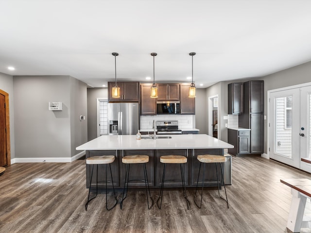 541 S Kelsey Ave, Evansville, IN 47714 - kitchen featuring appliances with stainless steel finishes, baseboards, wood finished floors, light countertops, and recessed lighting