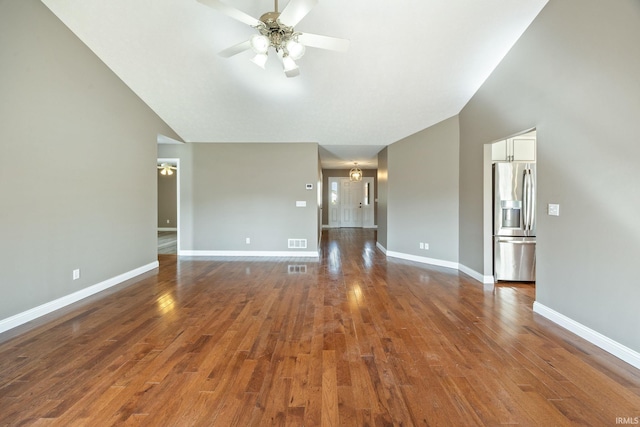 spare room with ceiling fan, wood finished floors, baseboards, and lofted ceiling