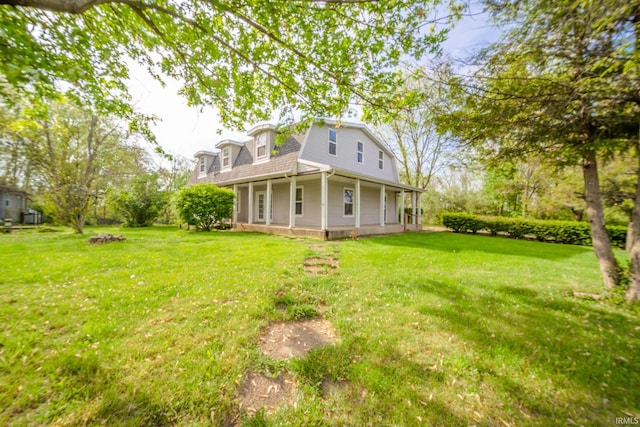 back of property featuring a lawn, a gambrel roof, a porch, and a shingled roof