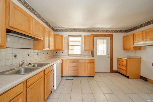 kitchen featuring a sink, dishwasher, baseboards, backsplash, and light countertops