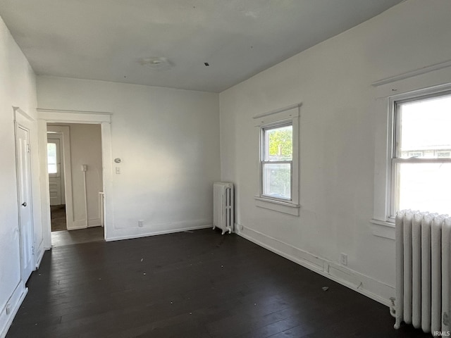 115 E 2nd St, Peru, IN 46970 - unfurnished room featuring radiator and dark wood-style floors