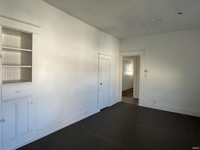 115 E 2nd St, Peru, IN 46970 - empty room with dark wood-style flooring and baseboards