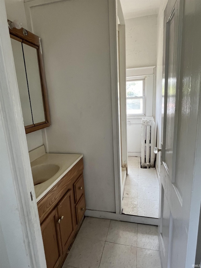 115 E 2nd St, Peru, IN 46970 - bathroom featuring radiator heating unit, vanity, and tile patterned floors