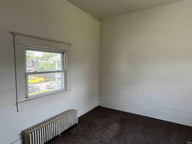 115 E 2nd St, Peru, IN 46970 - unfurnished room with radiator heating unit and dark colored carpet