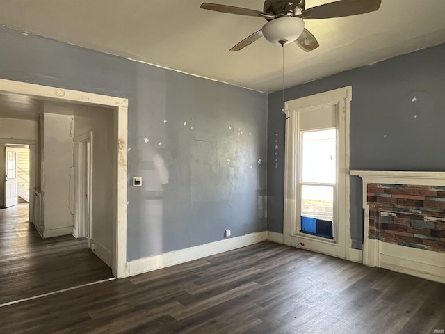 115 E 2nd St, Peru, IN 46970 - unfurnished living room featuring a ceiling fan, dark wood-style flooring, and plenty of natural light