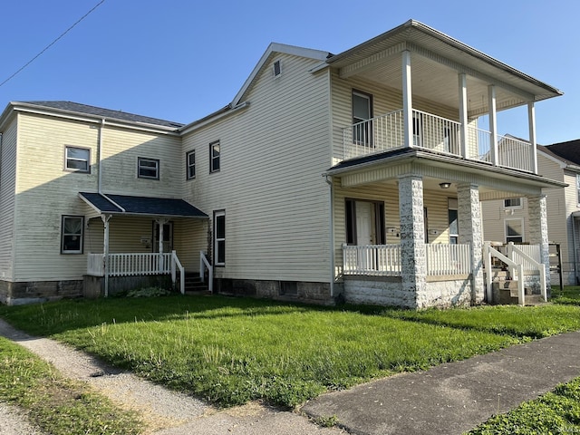 115 E 2nd St, Peru, IN 46970 - view of front of home featuring a porch, a balcony, and a front lawn