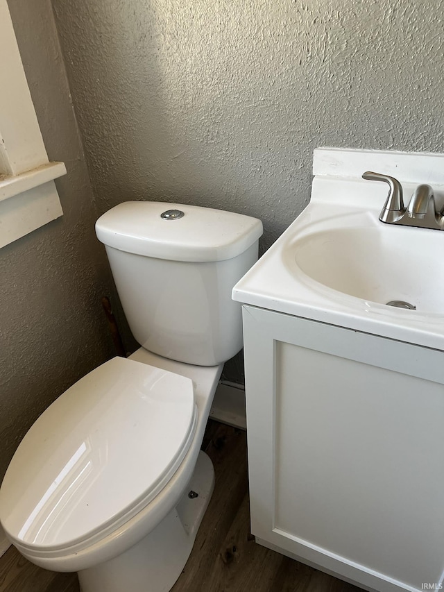 115 E 2nd St, Peru, IN 46970 - half bath with vanity, a textured wall, and wood finished floors