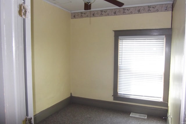 carpeted empty room featuring ceiling fan