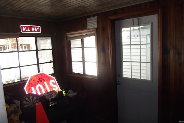entryway featuring wooden ceiling and wood walls
