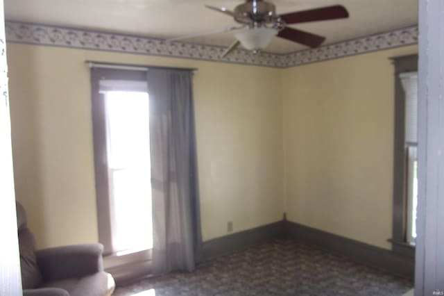 spare room with a ceiling fan
