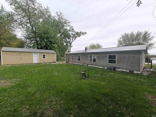 78 Ems B6 Ln, Leesburg, IN 46538 - back of property with a lawn, an outdoor structure, and central AC