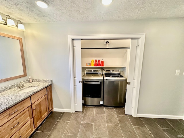 1700 W Taylor St, Kokomo, IN 46901 - washroom with separate washer and dryer, baseboards, and a textured ceiling