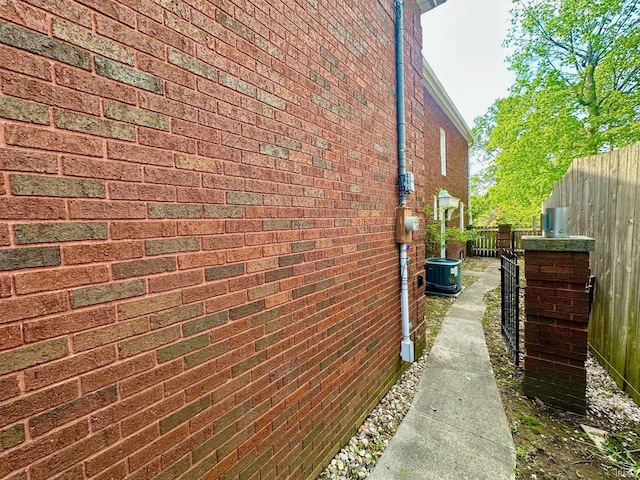 1700 W Taylor St, Kokomo, IN 46901 - view of side of home featuring brick siding, central AC, and fence