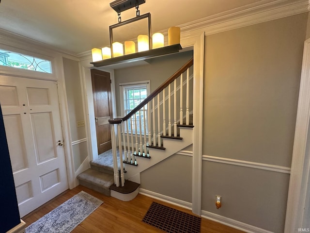 1700 W Taylor St, Kokomo, IN 46901 - entrance foyer with stairs, wood finished floors, baseboards, and crown molding