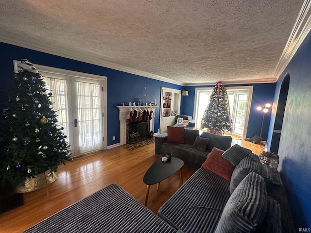 1700 W Taylor St, Kokomo, IN 46901 - living area with a textured ceiling, wood finished floors, a fireplace with flush hearth, arched walkways, and ornamental molding