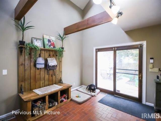 1700 W Taylor St, Kokomo, IN 46901 - mudroom featuring brick patterned floors and vaulted ceiling