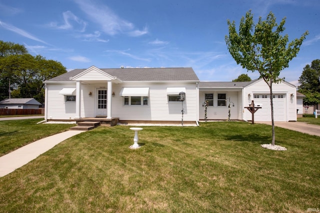 ranch-style home featuring an attached garage, a front yard, driveway, and a shingled roof