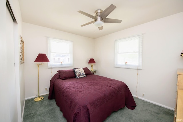 carpeted bedroom with multiple windows, baseboards, and a ceiling fan