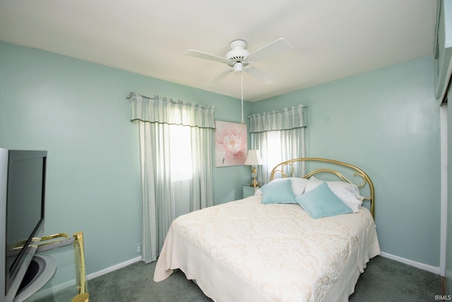 carpeted bedroom featuring baseboards and ceiling fan