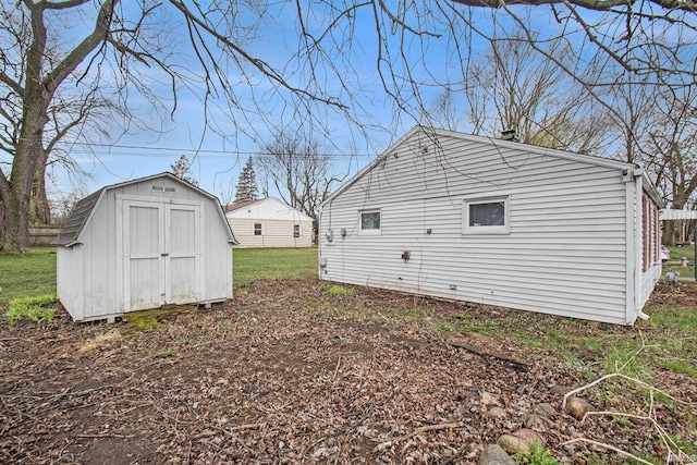 view of yard featuring a storage shed and an outbuilding
