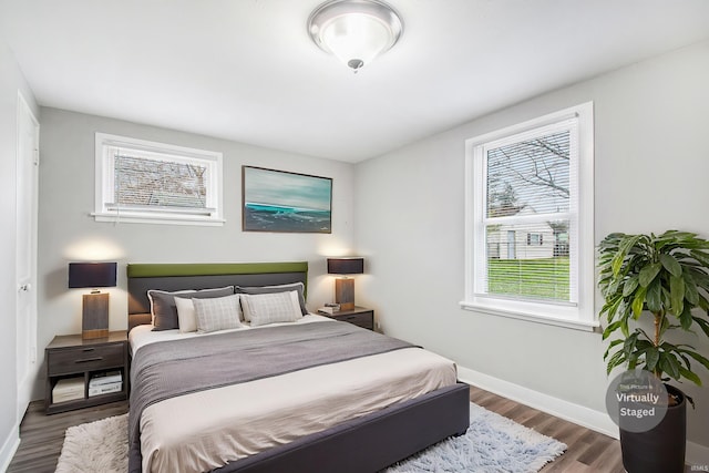 bedroom featuring wood finished floors and baseboards