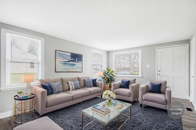living area featuring wood finished floors and baseboards
