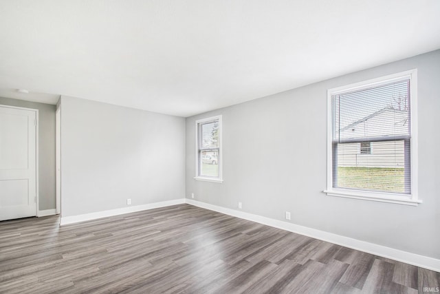 unfurnished room with wood finished floors and baseboards