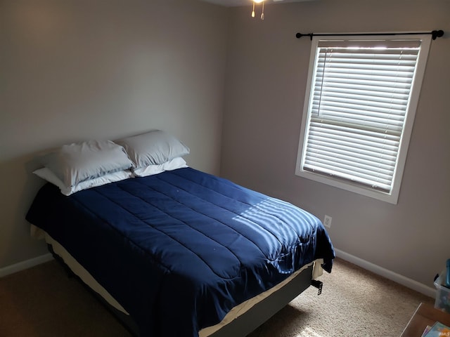 bedroom featuring baseboards and carpet floors