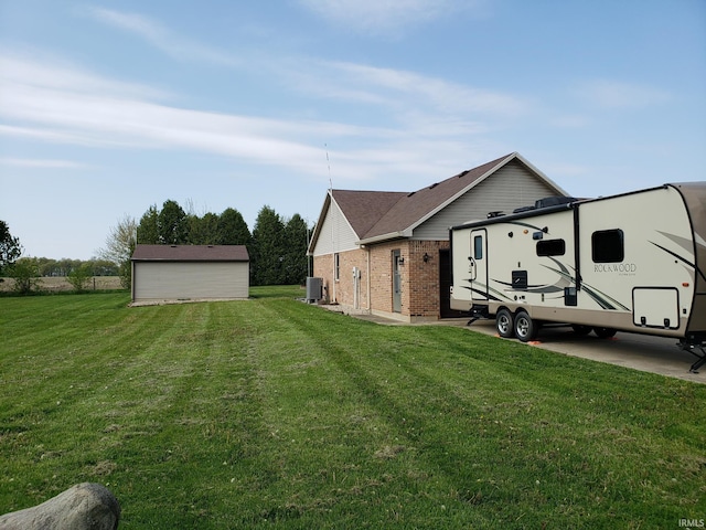 view of home's exterior featuring a yard, brick siding, and central air condition unit