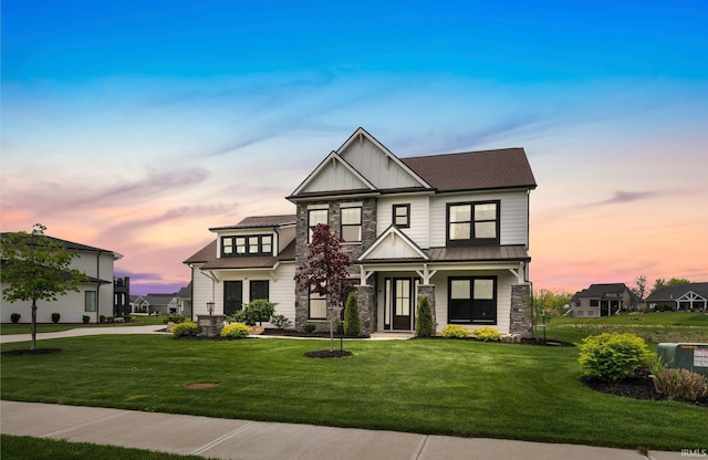 18015 Tullymore Ln, Leo, IN 46765 - view of front of house featuring stone siding, board and batten siding, a lawn, a standing seam roof, and metal roof