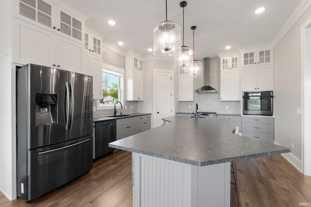 18015 Tullymore Ln, Leo, IN 46765 - kitchen featuring appliances with stainless steel finishes, wall chimney range hood, dark countertops, dark wood-style floors, and recessed lighting