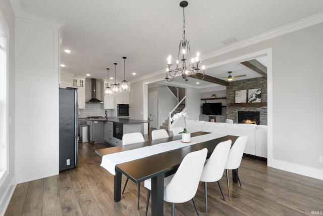 18015 Tullymore Ln, Leo, IN 46765 - dining room featuring ceiling fan, a fireplace, a chandelier, dark wood-style flooring, and recessed lighting