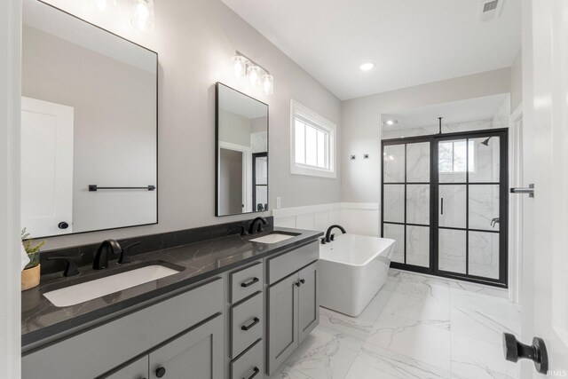 18015 Tullymore Ln, Leo, IN 46765 - bathroom featuring a stall shower, a soaking tub, double vanity, marble finish flooring, and recessed lighting
