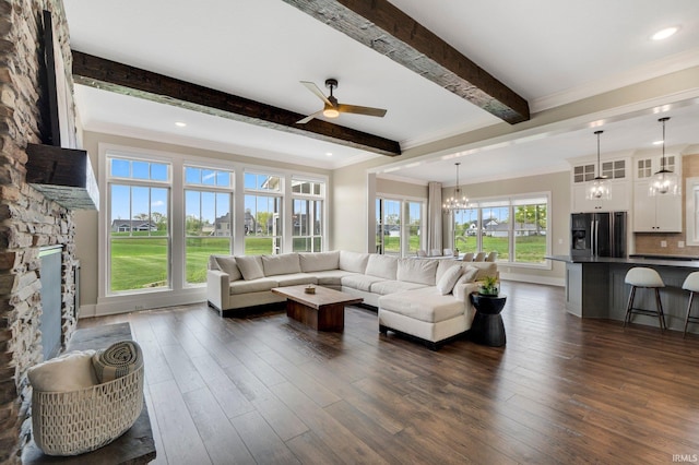 18015 Tullymore Ln, Leo, IN 46765 - living room with a ceiling fan, beamed ceiling, ornamental molding, a chandelier, and dark wood-style flooring