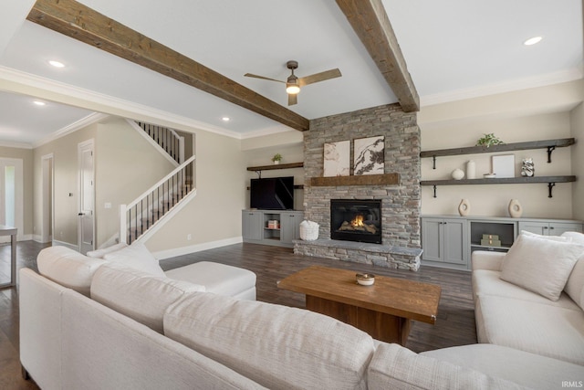 18015 Tullymore Ln, Leo, IN 46765 - living room featuring dark wood-type flooring, a ceiling fan, beamed ceiling, a stone fireplace, and baseboards