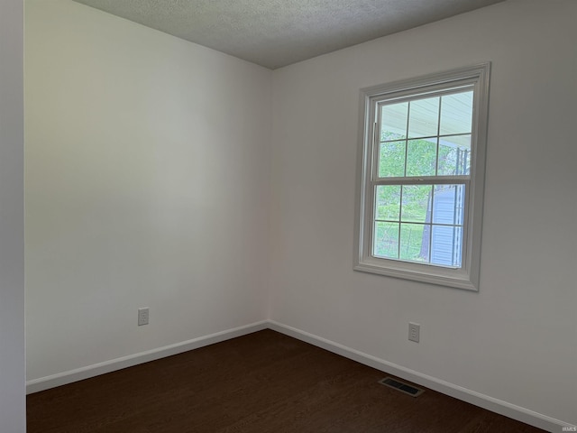 806 Smith Ave, Oolitic, IN 47451 - spare room featuring dark wood-style floors, baseboards, and a textured ceiling