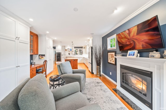 1327 E Wayne St, South Bend, IN 46615 - living area featuring light wood-style floors, ornamental molding, a fireplace with flush hearth, recessed lighting, and baseboards