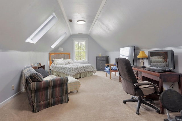 carpeted bedroom with a skylight, lofted ceiling, a desk, and baseboards
