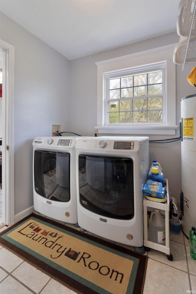 laundry area featuring tile patterned floors, washing machine and clothes dryer, and electric water heater