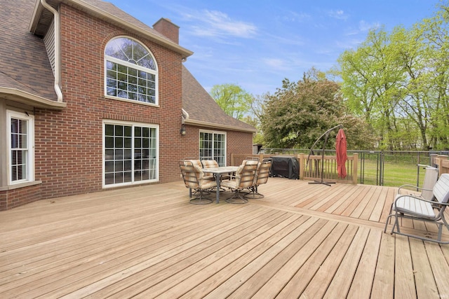 wooden terrace featuring outdoor dining space