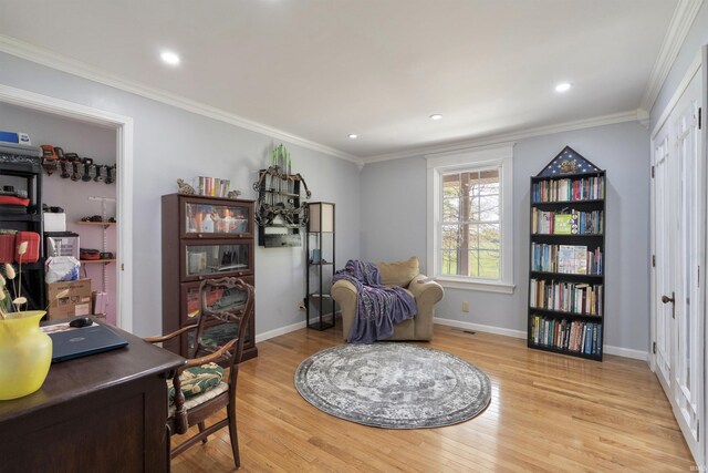 sitting room featuring light wood finished floors, baseboards, a desk, crown molding, and recessed lighting
