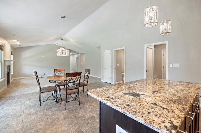 dining space with a chandelier, vaulted ceiling, baseboards, and light carpet