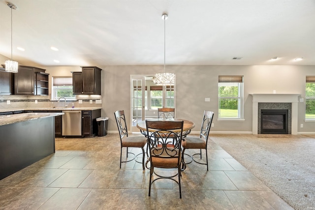 dining room featuring a glass covered fireplace, baseboards, and recessed lighting