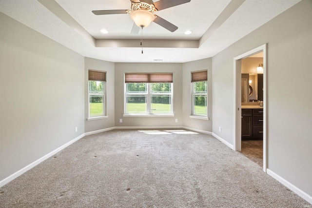 carpeted empty room with baseboards, a tray ceiling, a ceiling fan, and recessed lighting