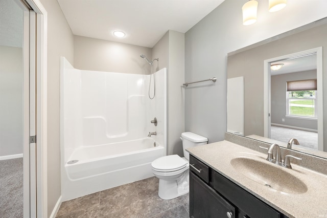 bathroom with toilet, vanity, bathing tub / shower combination, and baseboards
