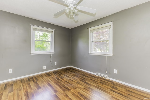unfurnished room featuring wood finished floors, baseboards, and ceiling fan
