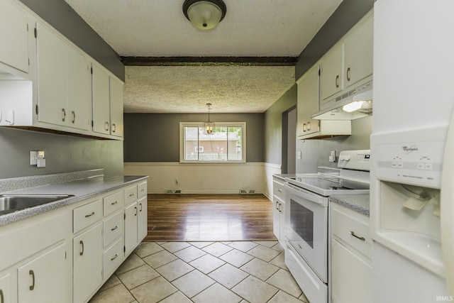 kitchen featuring white electric stove, under cabinet range hood, light tile patterned floors, a textured ceiling, and a sink