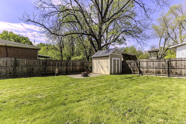view of yard with a shed, an outdoor structure, and a patio area