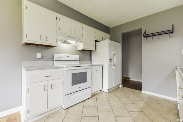 kitchen featuring white appliances, under cabinet range hood, light countertops, white cabinetry, and a textured ceiling